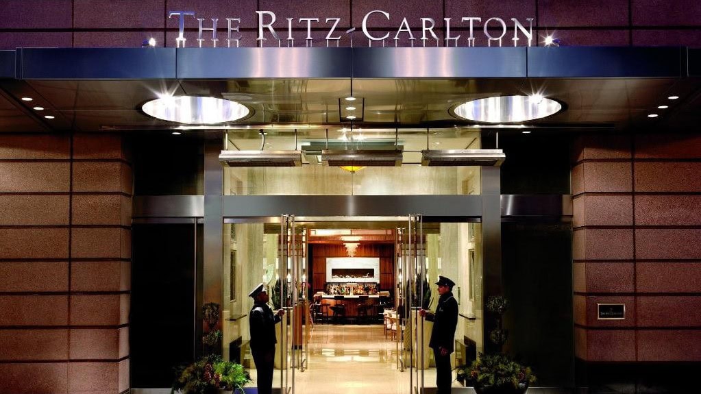 The ritz carlton boston main entrance with two men holding up the glass doors.