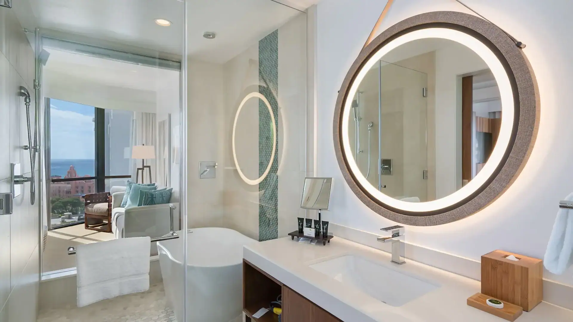 White bathroom with windows of Waikiki Beach, Bathtub, and shower at Hyatt Centric Waikiki Beach.