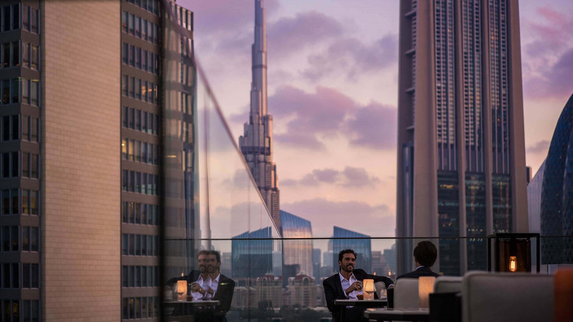 2 men sitting at the Luna rooftop bar