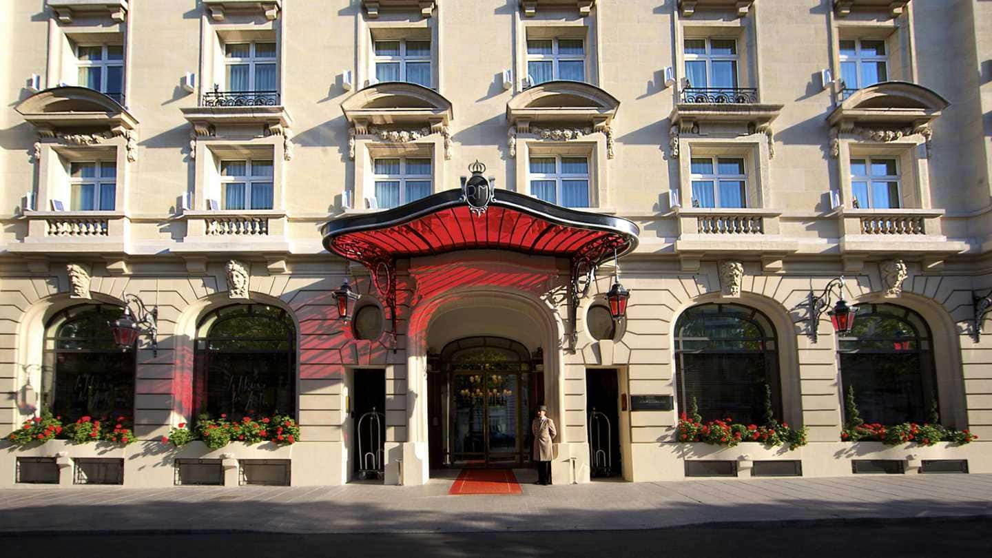 Main entrance of Le royal monceau Raffles with a doorman standing outside