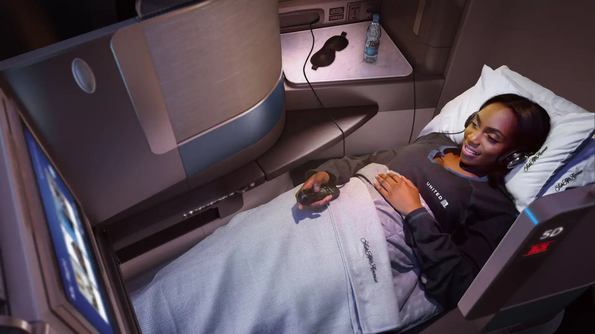 A woman watching tv on her businessclass seat