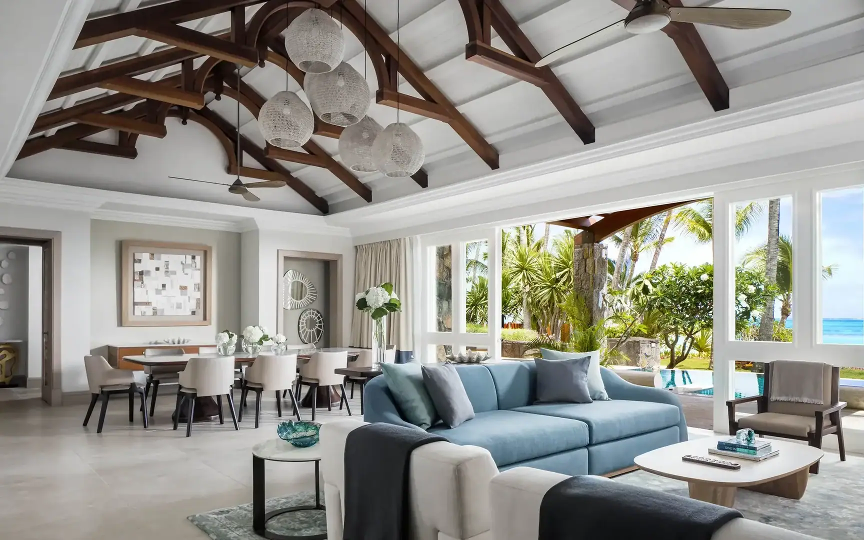 lounge and dinning area of a room at One&Only Le Saint Geran