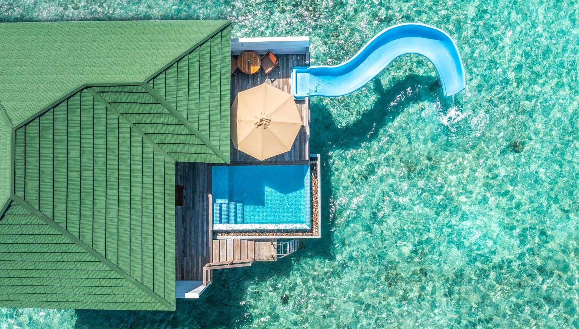 Suite at Siyam World laying on the water with pool, private waterslide, and green roof. 