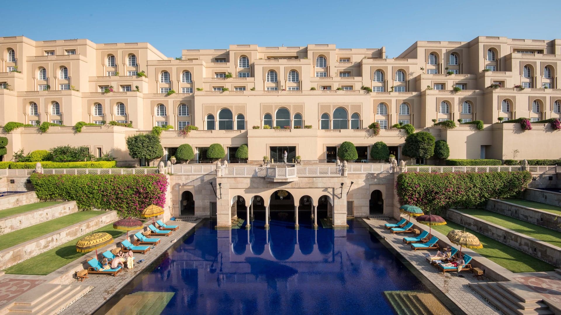 Outside view of Oberoi Amarvillas with the pool and sunbeds