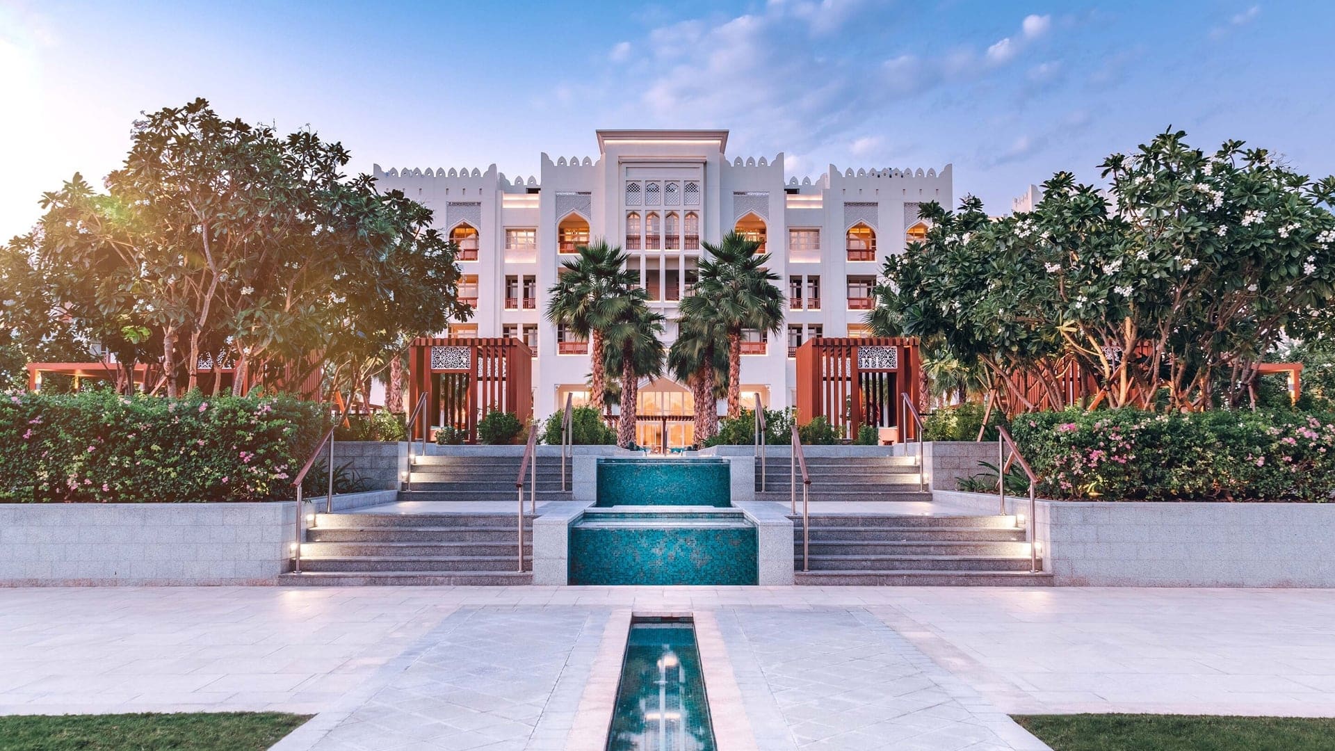 Outside photo of Al Messila Resort - A luxury collection resort å spa, With two staircases up to the beautiful hotel and outside nature for aesthetics.