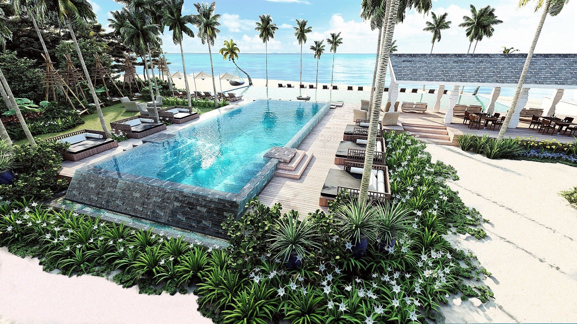 Infinity pool with sunbeds and beach at Cora Cora Maldives.